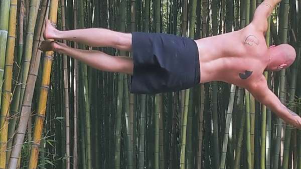 Max performing a human flag during a calisthenics workout