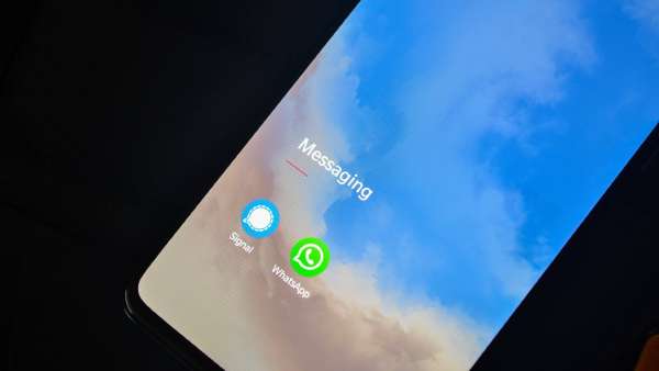 WhatsApp and Signal logos compared on two phones